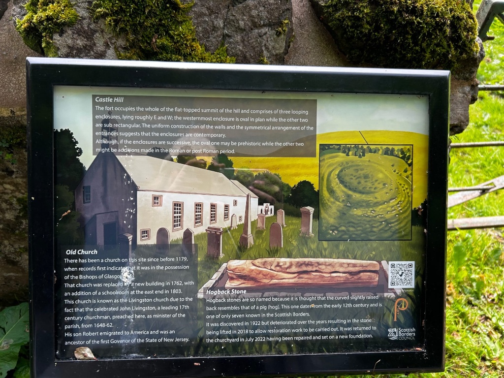 Informational sign at a historical site, likely in Scotland. The sign details the history of Castle Hill, a fort with three enclosures, and the Old Church located there. It mentions the church's history, its association with John Livingston, a significant 17th-century figure, and the lineage connecting him to a New Jersey governor. The sign also describes a Hogback Stone, a unique type of carved stone found at the site, its discovery, deterioration, and eventual restoration. The illustrations on the sign aid in visualising the historical features. The overall theme is the historical and archaeological significance of the location.