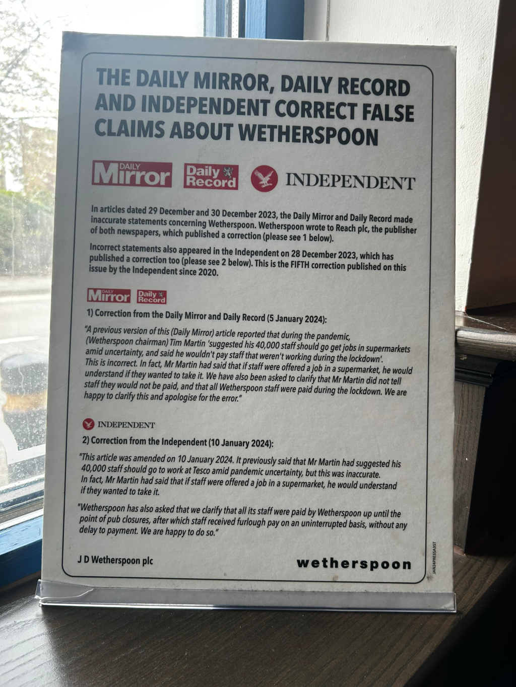 A notice posted by JD Wetherspoon plc. It displays corrections issued by the Daily Mirror, Daily Record, and The Independent regarding inaccurate statements made in their articles concerning Wetherspoon's actions during the COVID-19 pandemic. The corrections clarify that Wetherspoon did not tell staff they would not be paid and that all staff received pay during the lock down, addressing previous claims suggesting otherwise. The notice highlights that these are not the first corrections published by these newspapers on this topic.