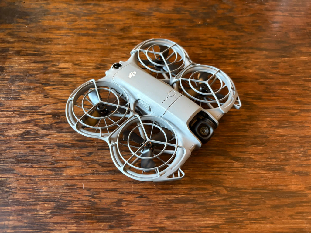Lone tent pitched in a grassy field near a ring of standing stones under a twilight sky. The scene evokes a sense of solitude and connection to ancient history. The minimalist composition emphasises the vastness of the landscape and the smallness of the human presence within it.